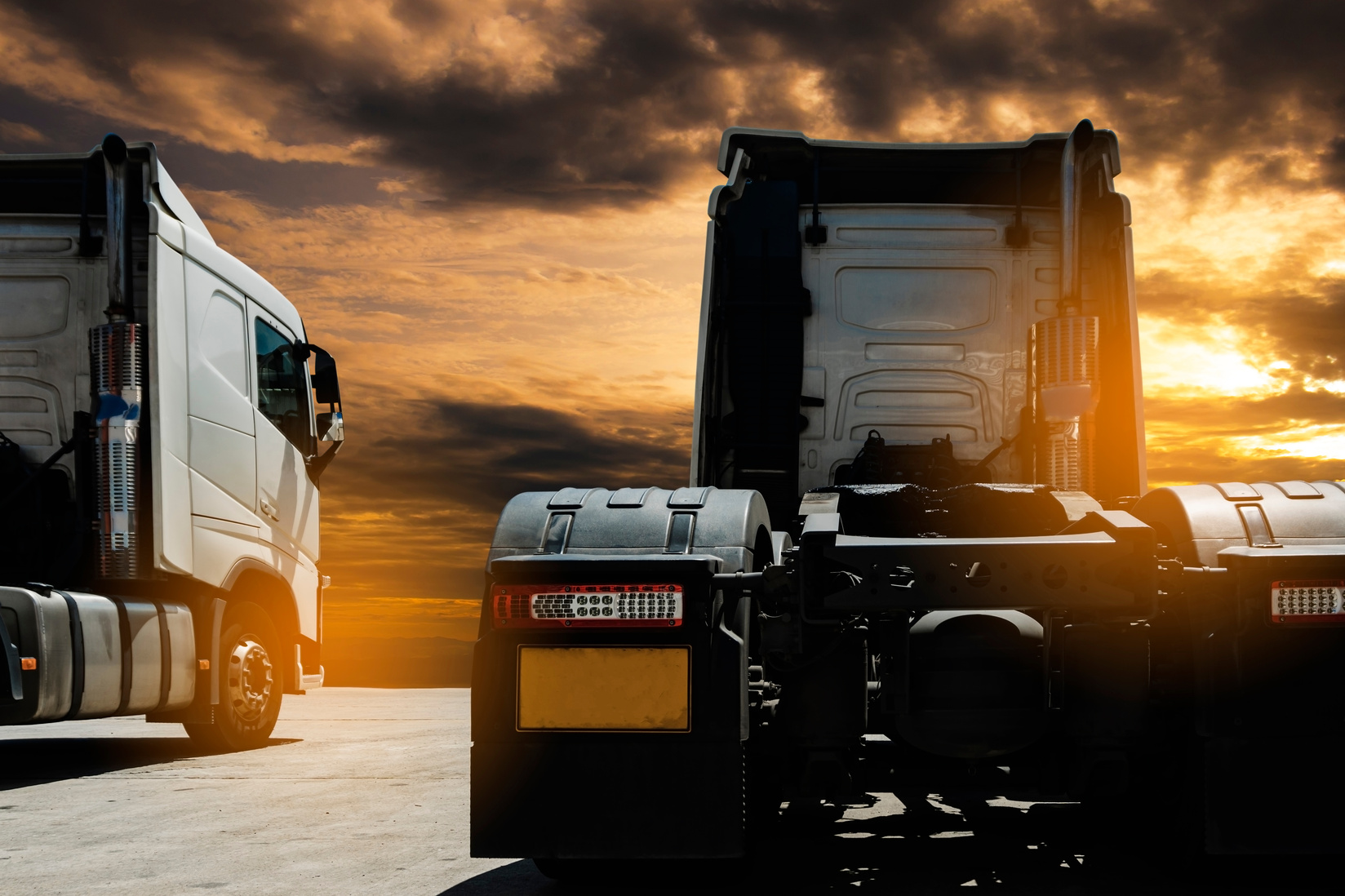 Truck transportation, semi truck parking at sunset sky